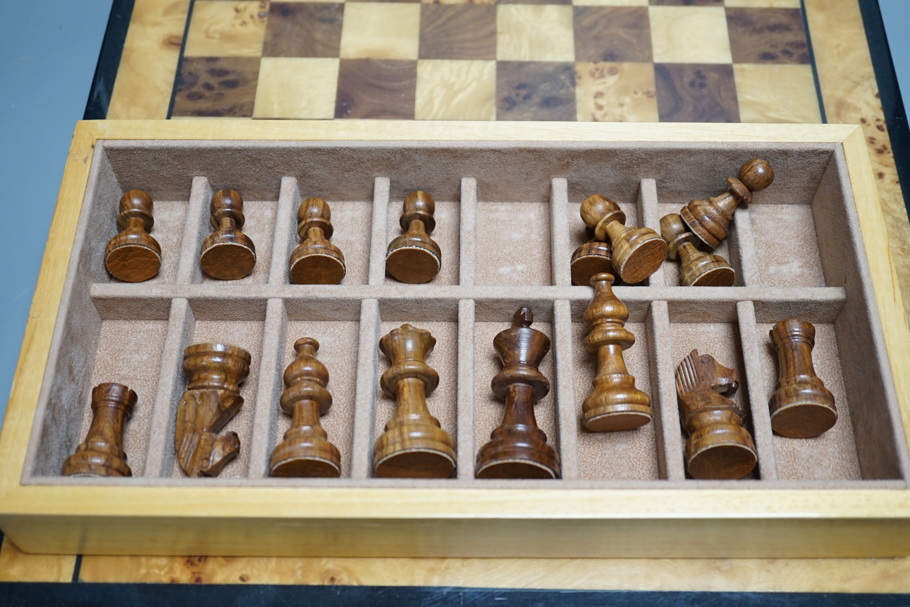 A cased Backgammon set and a chess set with chess-board top and drawers for chess pieces, chess box 35.5 cms x 35.5 cms.
